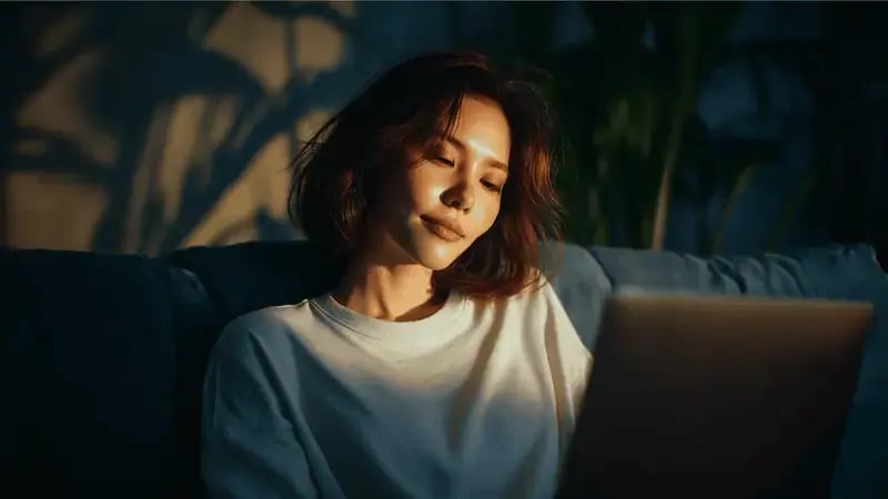 female person looking at laptop